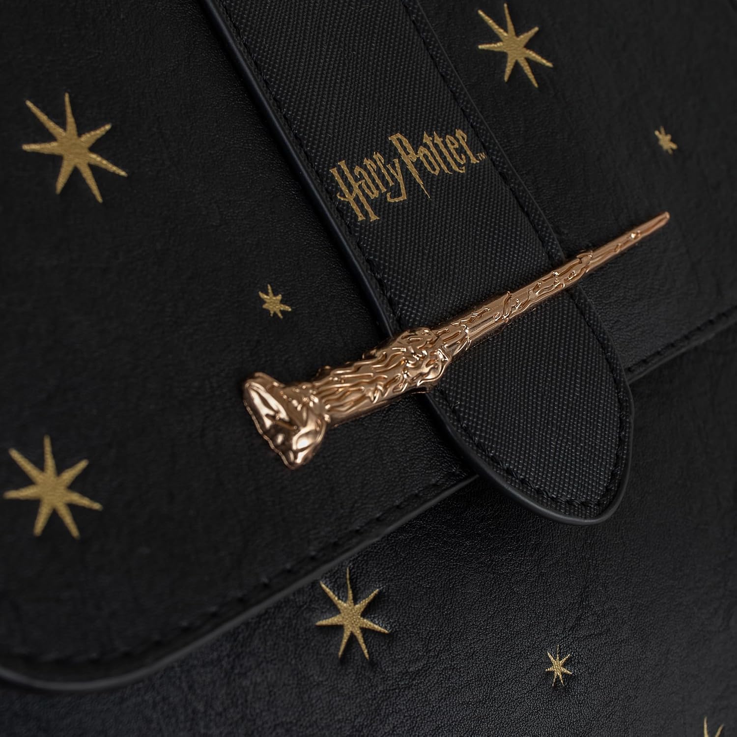 Dettaglio logo Harry Potter e bacchetta dorata sulla borsa